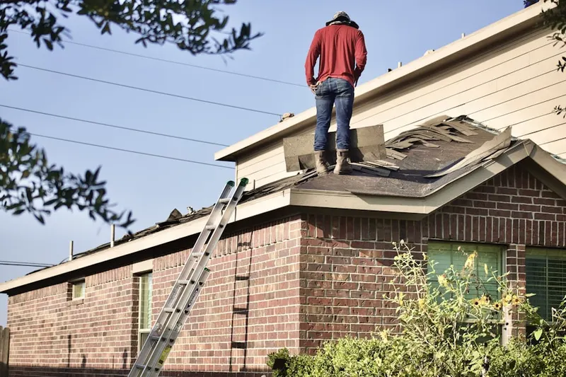 Professional roofer working on a residential roof in Harmony Towne